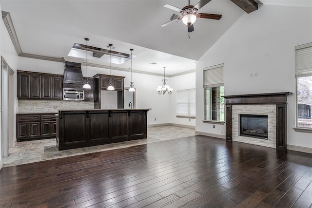 328 SW 175th Ter, Oklahoma City, OK 73170 - kitchen with stainless steel microwave, a ceiling fan, a chandelier, dark brown cabinets, and healthy amount of natural light