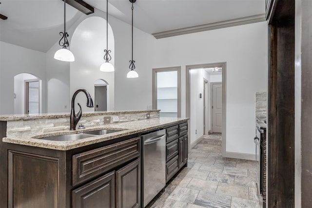 328 SW 175th Ter, Oklahoma City, OK 73170 - kitchen with stainless steel dishwasher, a sink, dark brown cabinetry, baseboards, and stone tile floors