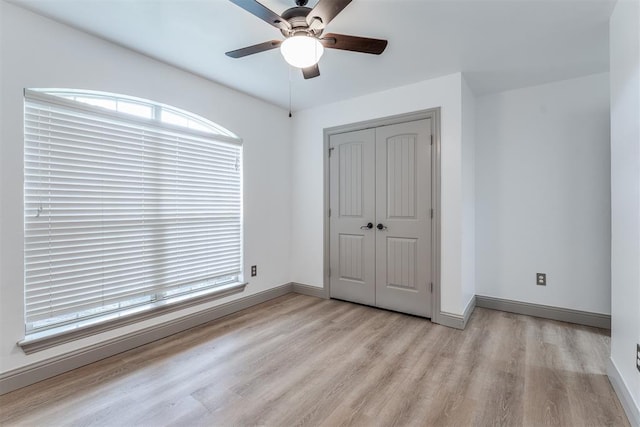 328 SW 175th Ter, Oklahoma City, OK 73170 - unfurnished bedroom with wood finished floors, baseboards, a closet, and ceiling fan