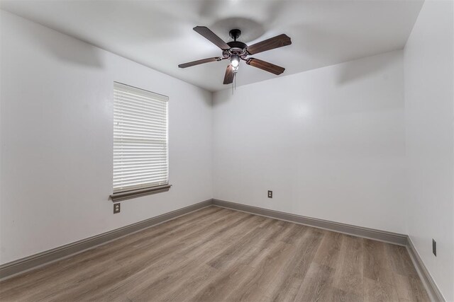 328 SW 175th Ter, Oklahoma City, OK 73170 - unfurnished room with wood finished floors, a ceiling fan, and baseboards