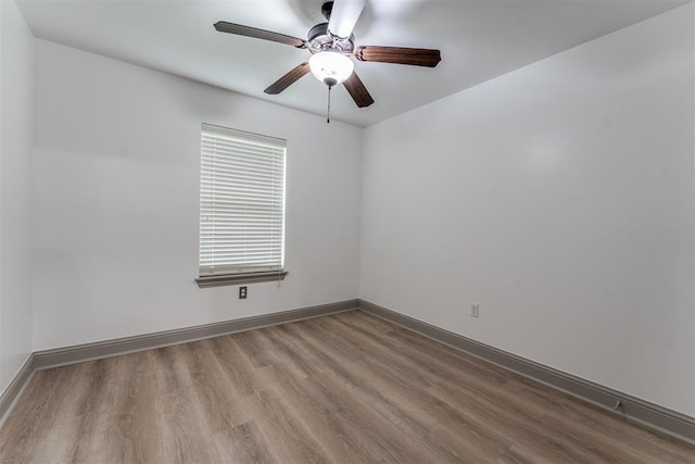 328 SW 175th Ter, Oklahoma City, OK 73170 - empty room with wood finished floors, a ceiling fan, and baseboards