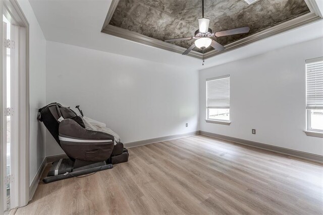 328 SW 175th Ter, Oklahoma City, OK 73170 - unfurnished room with a raised ceiling, light wood-style flooring, plenty of natural light, and a ceiling fan