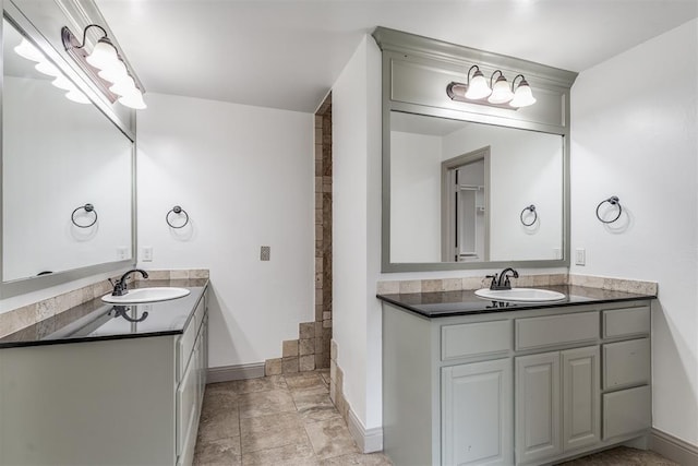 328 SW 175th Ter, Oklahoma City, OK 73170 - bathroom with two vanities, baseboards, and a shower