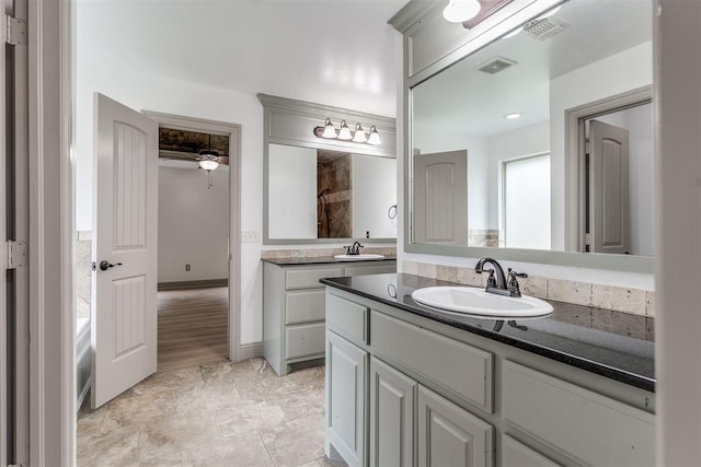 328 SW 175th Ter, Oklahoma City, OK 73170 - bathroom with vanity, a tile shower, and a ceiling fan