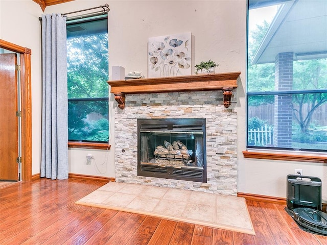 113 Stone Creek Dr, Midwest City, OK 73130 - detailed view of wood finished floors, baseboards, and a fireplace