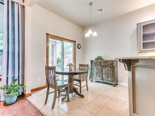 113 Stone Creek Dr, Midwest City, OK 73130 - dining area with baseboards, light tile patterned floors, and a chandelier