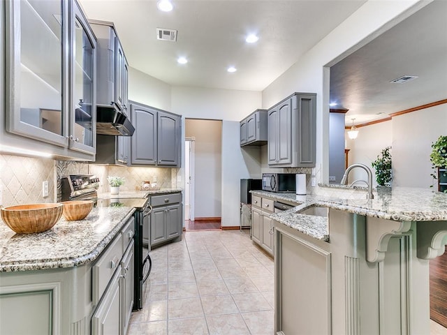 113 Stone Creek Dr, Midwest City, OK 73130 - kitchen with gray cabinetry, electric stove, a peninsula, a sink, and glass insert cabinets