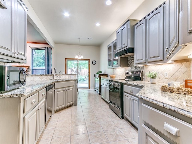 113 Stone Creek Dr, Midwest City, OK 73130 - kitchen with appliances with stainless steel finishes, gray cabinets, a sink, decorative backsplash, and a chandelier