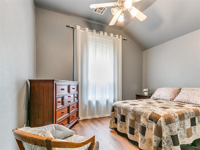 113 Stone Creek Dr, Midwest City, OK 73130 - bedroom with light wood-style floors, vaulted ceiling, and ceiling fan