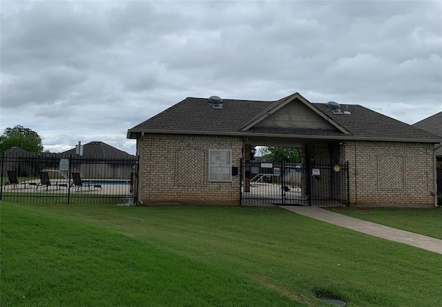 113 Stone Creek Dr, Midwest City, OK 73130 - back of house with a shingled roof, brick siding, and a gate