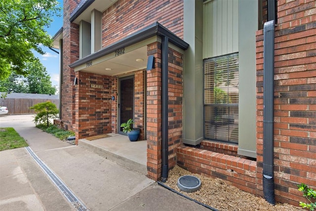 7802 Old Hickory Ln, Oklahoma City, OK 73116 - doorway to property featuring brick siding