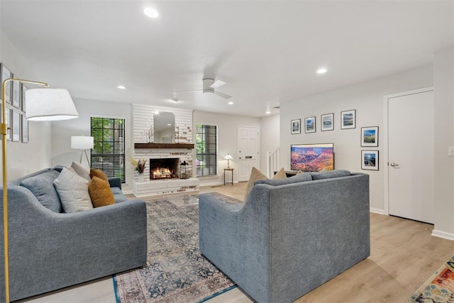 7802 Old Hickory Ln, Oklahoma City, OK 73116 - living room featuring a ceiling fan, a fireplace, light wood-style flooring, recessed lighting, and baseboards