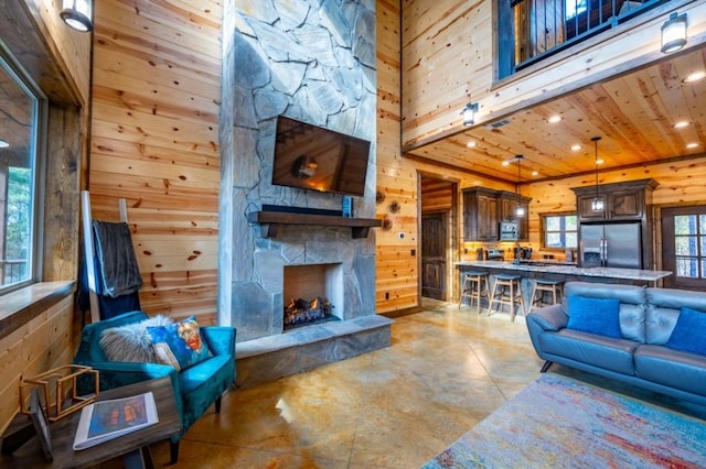 59 Sweet Elm, Broken Bow, OK 74728 - living area with wood walls, concrete flooring, recessed lighting, a fireplace, and wood ceiling