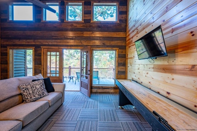 59 Sweet Elm, Broken Bow, OK 74728 - living room featuring wooden walls, healthy amount of natural light, and a high ceiling