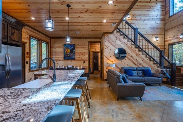 59 Sweet Elm, Broken Bow, OK 74728 - kitchen with stainless steel fridge with ice dispenser, wooden walls, concrete floors, wooden ceiling, and recessed lighting