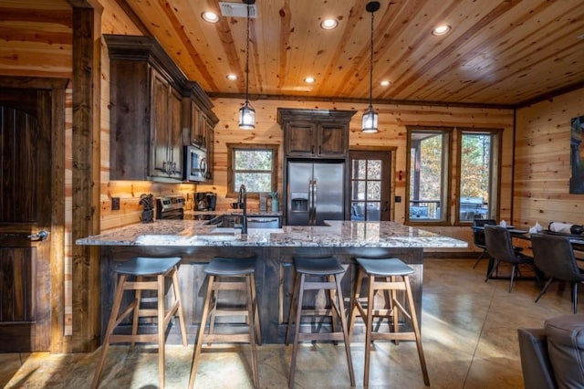 59 Sweet Elm, Broken Bow, OK 74728 - kitchen with stainless steel appliances, wooden walls, recessed lighting, healthy amount of natural light, and a peninsula
