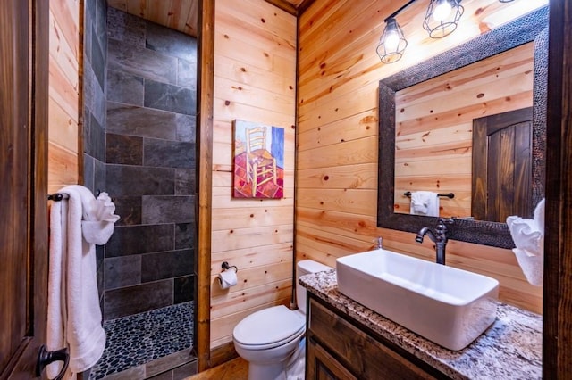 59 Sweet Elm, Broken Bow, OK 74728 - full bathroom with vanity, toilet, wooden walls, and a tile shower