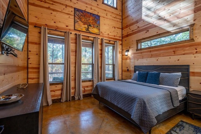 59 Sweet Elm, Broken Bow, OK 74728 - bedroom with wood walls, a towering ceiling, multiple windows, and finished concrete floors