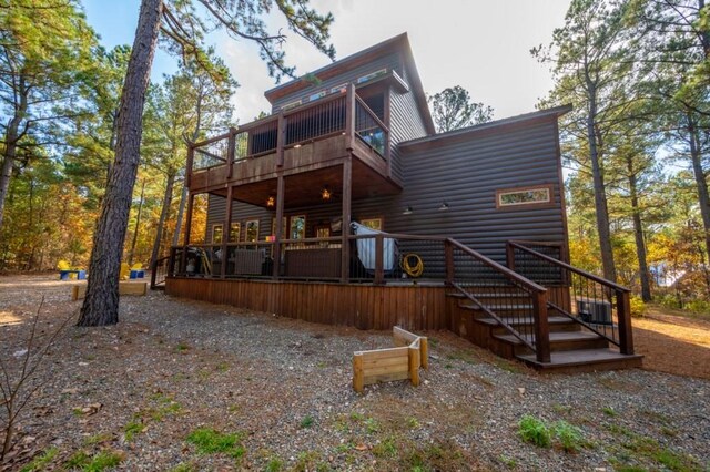 59 Sweet Elm, Broken Bow, OK 74728 - back of house featuring log veneer siding, a balcony, a deck, and stairs