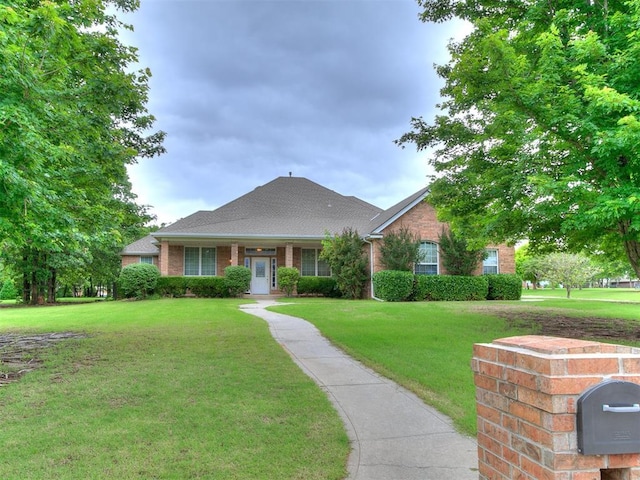 16441 Roserock Cir, Choctaw, OK 73020 - view of front of house with a front yard, brick siding, and roof with shingles