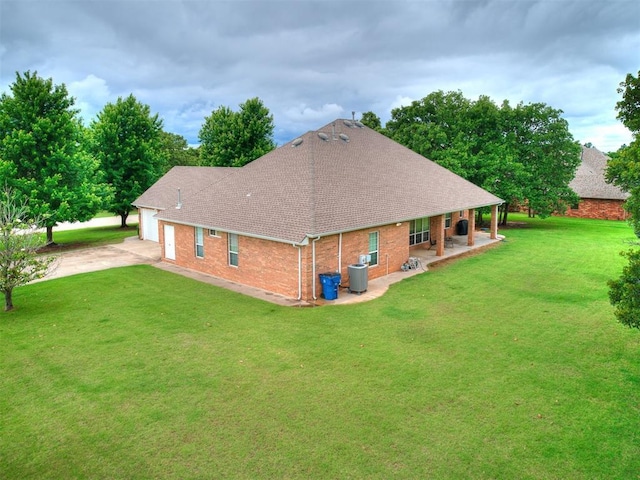 16441 Roserock Cir, Choctaw, OK 73020 - rear view of house with a shingled roof, an attached garage, driveway, and a lawn