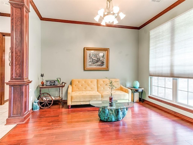 16441 Roserock Cir, Choctaw, OK 73020 - living area with light wood-style flooring, a chandelier, ornamental molding, baseboards, and decorative columns