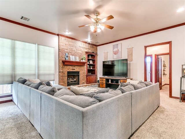 16441 Roserock Cir, Choctaw, OK 73020 - living area featuring light colored carpet, ceiling fan, ornamental molding, and a brick fireplace