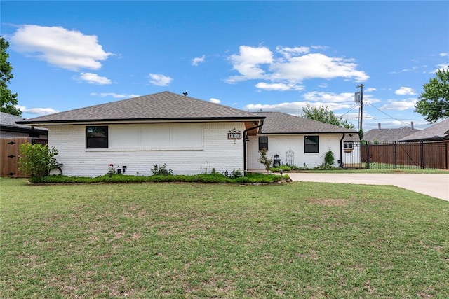 1113 Winnipeg Dr, Yukon, OK 73099 - view of front facade with brick siding, driveway, a gate, and a shingled roof