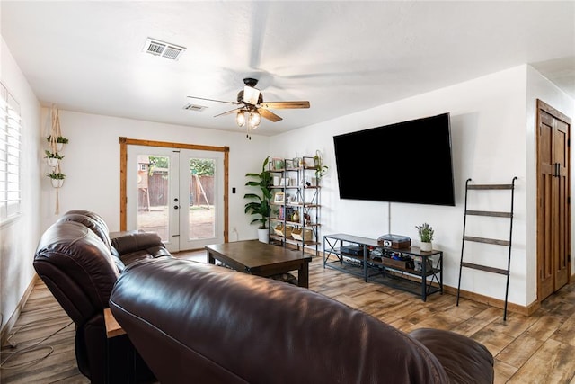 1113 Winnipeg Dr, Yukon, OK 73099 - living room featuring french doors, ceiling fan, wood finished floors, and baseboards