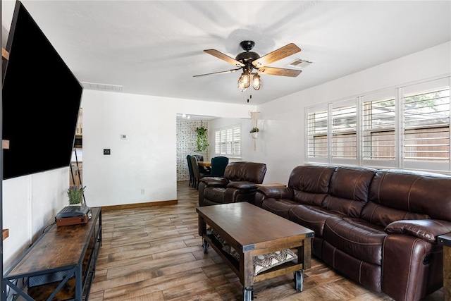 1113 Winnipeg Dr, Yukon, OK 73099 - living area with a ceiling fan, wood finished floors, and baseboards
