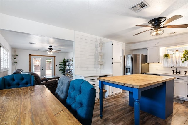 1113 Winnipeg Dr, Yukon, OK 73099 - kitchen with ceiling fan, wood counters, a sink, stainless steel fridge with ice dispenser, and white cabinetry