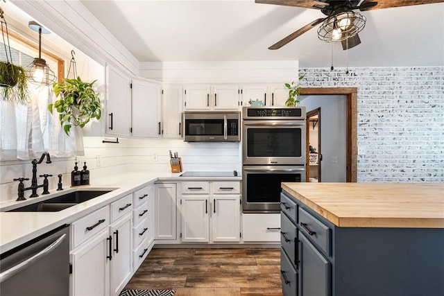 1113 Winnipeg Dr, Yukon, OK 73099 - kitchen featuring stainless steel appliances, a sink, ceiling fan, and white cabinets