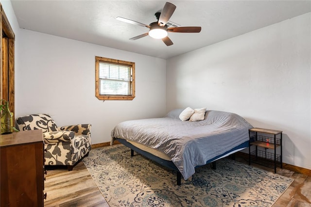 1113 Winnipeg Dr, Yukon, OK 73099 - bedroom featuring baseboards, wood finished floors, and a ceiling fan