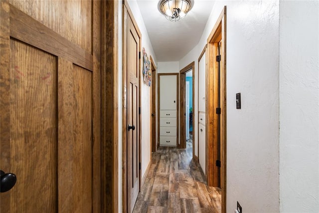 1113 Winnipeg Dr, Yukon, OK 73099 - corridor featuring dark wood-style flooring and a textured wall