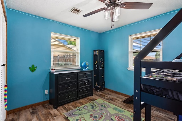 1113 Winnipeg Dr, Yukon, OK 73099 - bedroom with dark wood-style floors, baseboards, and a ceiling fan