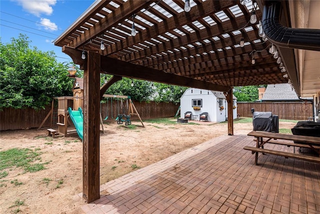 1113 Winnipeg Dr, Yukon, OK 73099 - fenced backyard with a playground, a patio, and a pergola