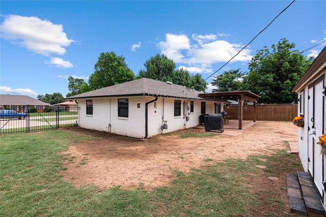 1113 Winnipeg Dr, Yukon, OK 73099 - rear view of house with a patio area, brick siding, and roof with shingles