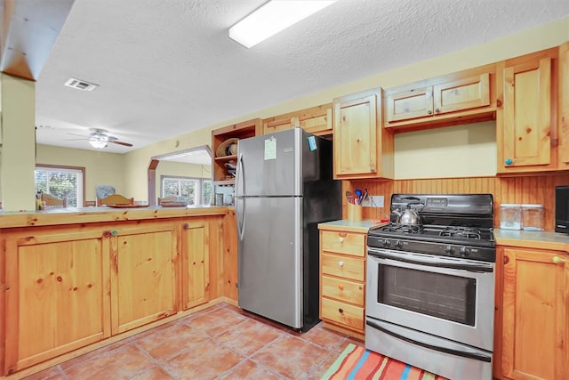 23596 Beach Haven Dr, Granite, OK 73547 - kitchen with appliances with stainless steel finishes, light countertops, ceiling fan, and a textured ceiling