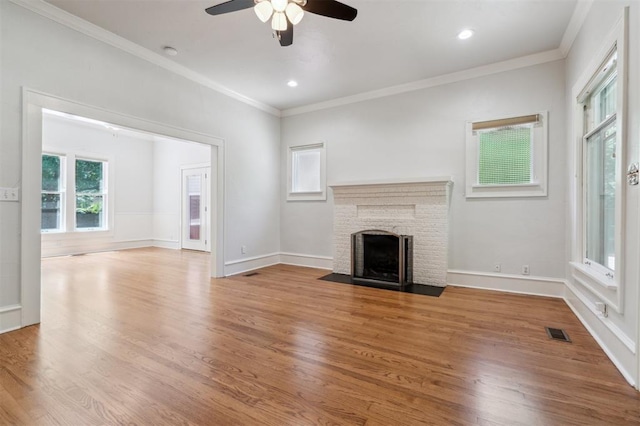 430 W Symmes St, Norman, OK 73069 - unfurnished living room with a ceiling fan, a fireplace, wood finished floors, ornamental molding, and recessed lighting