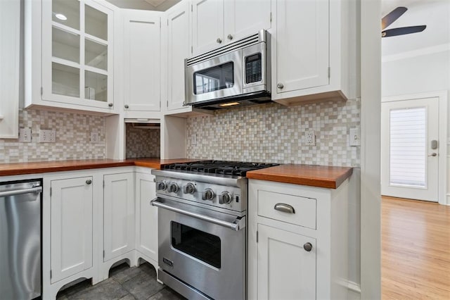 430 W Symmes St, Norman, OK 73069 - kitchen with wooden counters, stainless steel appliances, a ceiling fan, glass insert cabinets, and tasteful backsplash