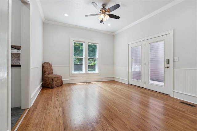430 W Symmes St, Norman, OK 73069 - empty room featuring a wainscoted wall, wood finished floors, crown molding, and ceiling fan