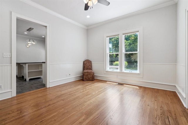 430 W Symmes St, Norman, OK 73069 - empty room featuring a wainscoted wall, a ceiling fan, crown molding, and wood finished floors
