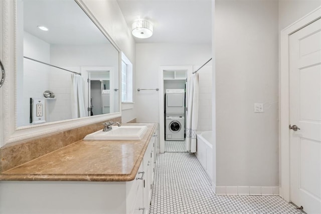 430 W Symmes St, Norman, OK 73069 - full bathroom with stacked washer / drying machine, vanity, shower / tub combo, tile patterned floors, and baseboards