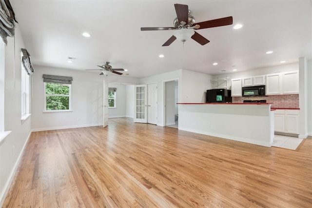 430 W Symmes St, Norman, OK 73069 - unfurnished living room featuring a ceiling fan, recessed lighting, light wood-type flooring, and baseboards