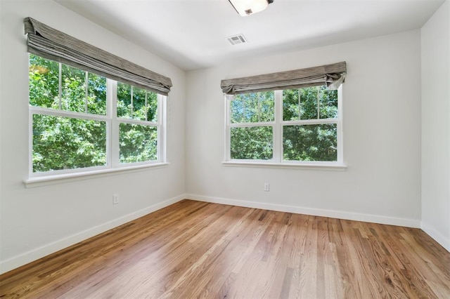 430 W Symmes St, Norman, OK 73069 - unfurnished room with plenty of natural light, baseboards, and light wood finished floors
