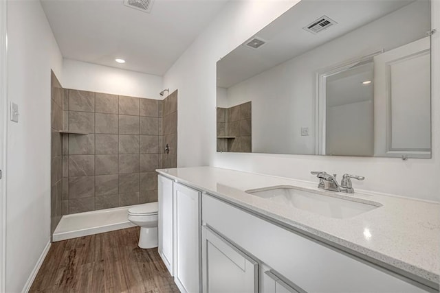 3717 Palmetto Bluff Dr, Mustang, OK 73064 - bathroom with toilet, vanity, tiled shower, wood finished floors, and recessed lighting