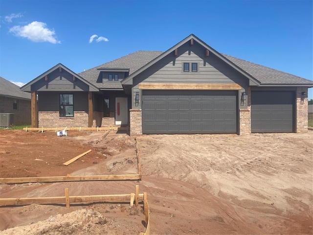 5100 Misty Wood Ln, Mustang, OK 73064 - craftsman inspired home featuring an attached garage, brick siding, driveway, and a shingled roof