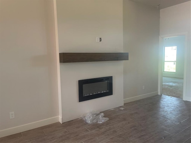 5100 Misty Wood Ln, Mustang, OK 73064 - unfurnished living room featuring wood finished floors and a glass covered fireplace