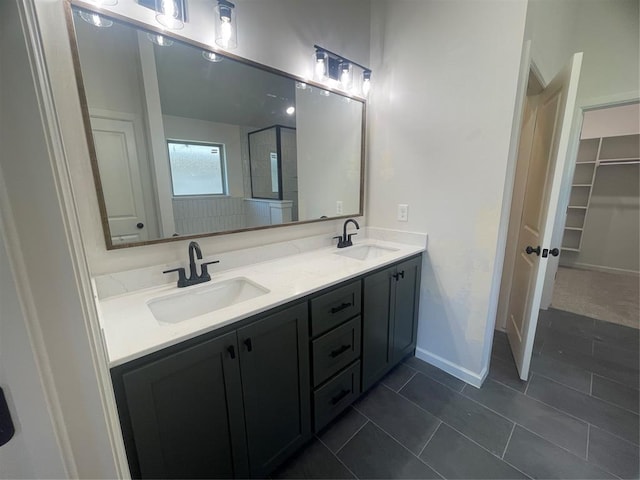 5100 Misty Wood Ln, Mustang, OK 73064 - full bathroom with double vanity, tile patterned floors, and a spacious closet