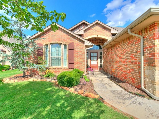 15508 Homecoming Dr, Edmond, OK 73013 - entrance to property with brick siding and a lawn
